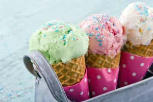 Three ice cream cones in a metal basket on blue wooden vintage background; Shutterstock ID 135808091; purchase_order: -; job: -; client: -; other: -