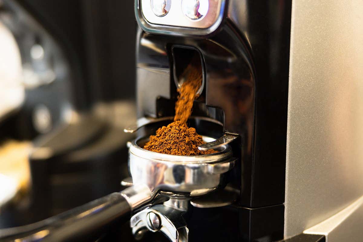 Finely ground coffee is dispensed into an espresso filter