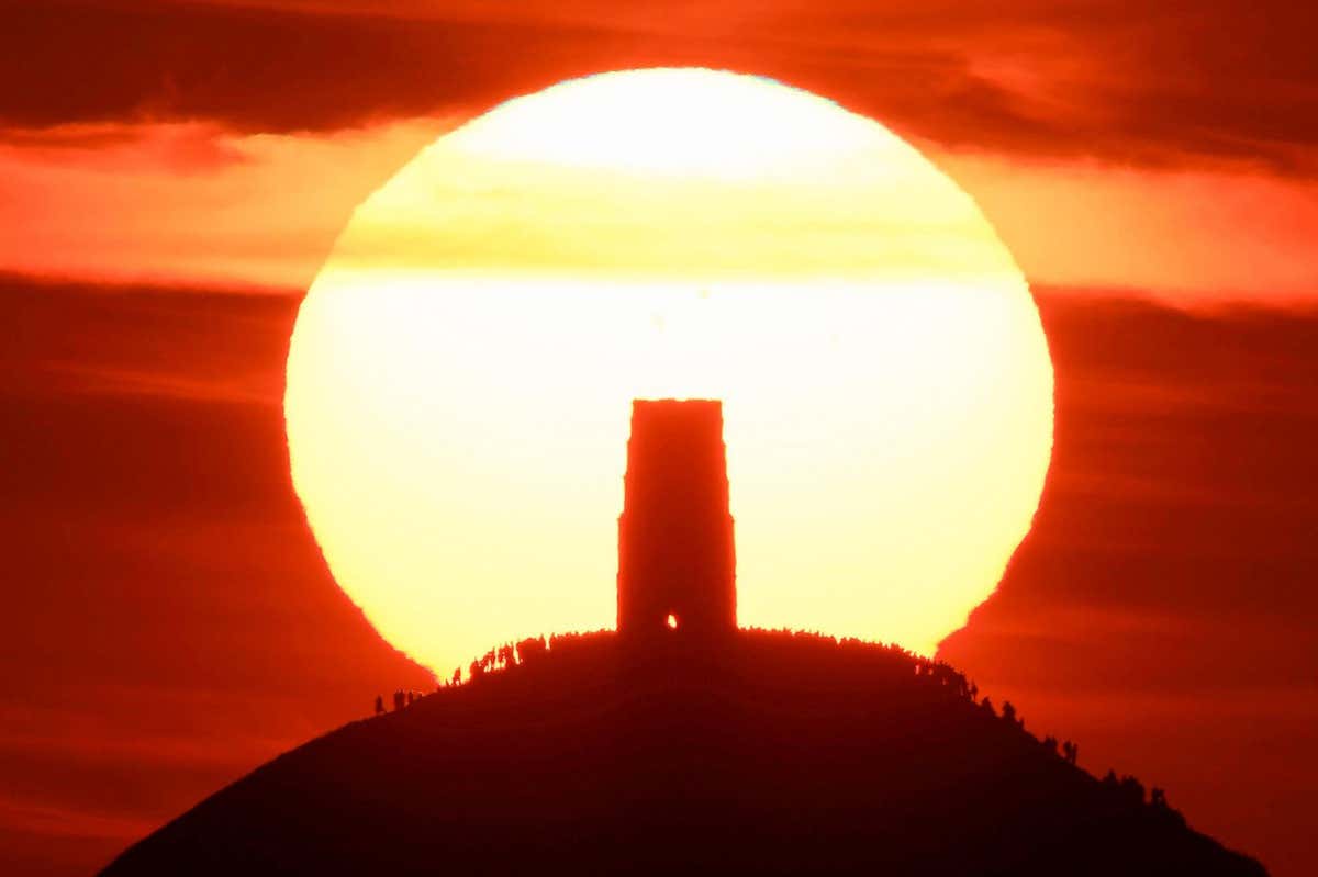 People at Glastonbury Tor in Somerset, UK on the summer solstice