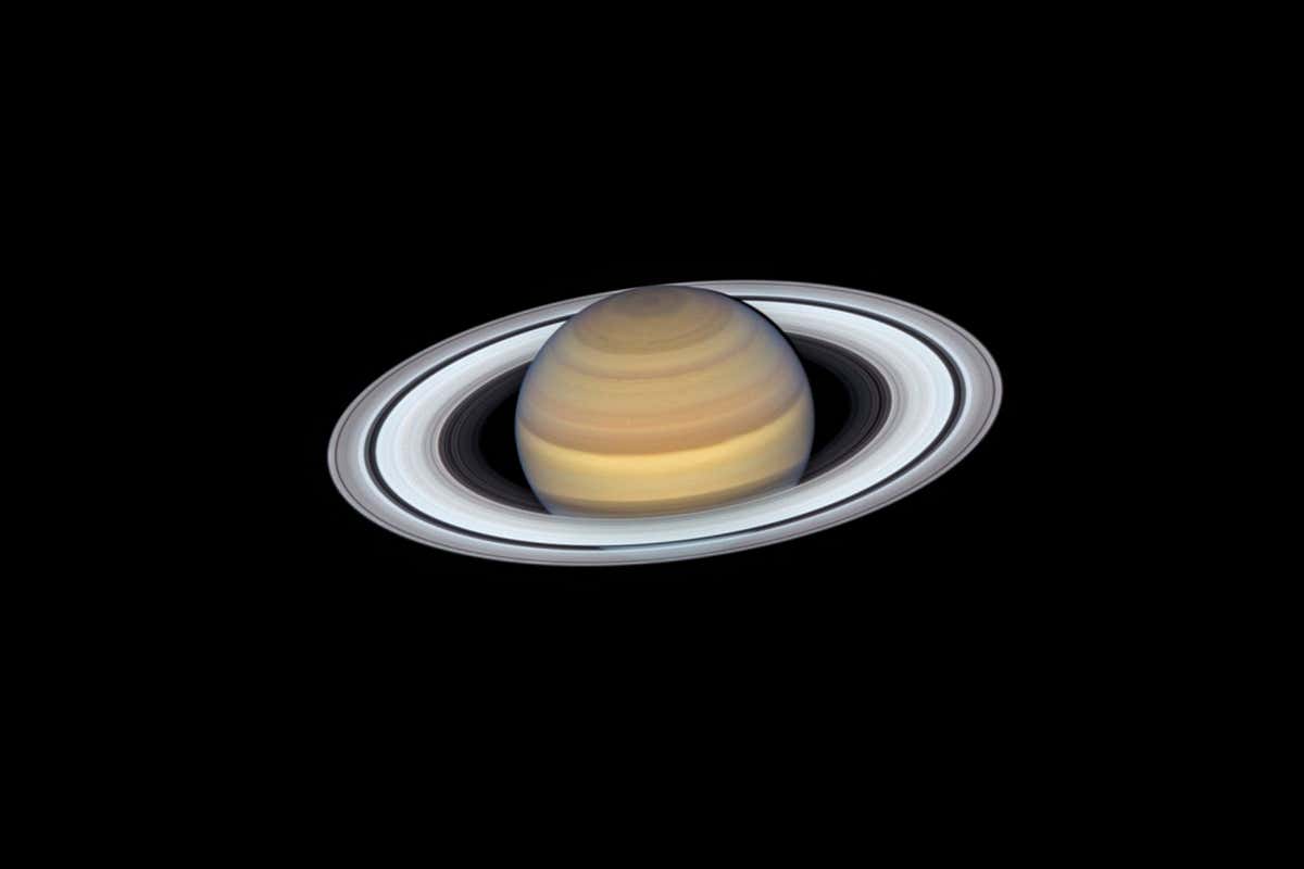 Release Date September 12, 2019 10:00AM (EDT) Caption Anyone who has ever peered at Saturn through a small telescope is immediately enticed by its elegant rings, which make the far-flung planet one of the most exotic-looking, opulent worlds in the solar system. The latest view of Saturn from NASA's Hubble Space Telescope captures exquisite details of the ring system?which looks like a phonograph record with grooves that represent detailed structure within the rings?and atmospheric details that once could only be captured by spacecraft visiting the distant world. One such intriguing feature is the long-lasting hexagon-shaped structure circling the planet's north pole. It is a mysterious six-sided pattern caused by a high-speed jet stream. NASA's Voyager 1 spacecraft first discovered the "hexagon" during its flyby in 1981. The hexagon is so large that four Earths could fit inside its boundaries. (There is no similar structure at Saturn's south pole.) Other features, however, are not as long lasting. A large storm in the north polar region spotted by Hubble last year has disappeared. Smaller, convective storms?called super "thunderheads"?such as the one just above the center of the planet's image, also come and go.