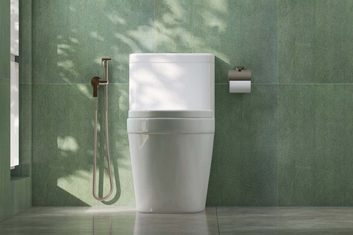 3D render modern white porcelain ceramic toilet bowl with stainless steel bidet shower spray and toilet-roll holder in a bathroom. Teal green granite wall tiles, Morning, Sunlight, Clean, Marble floor; Shutterstock ID 2205794535; purchase_order: -; job: -; client: -; other: -