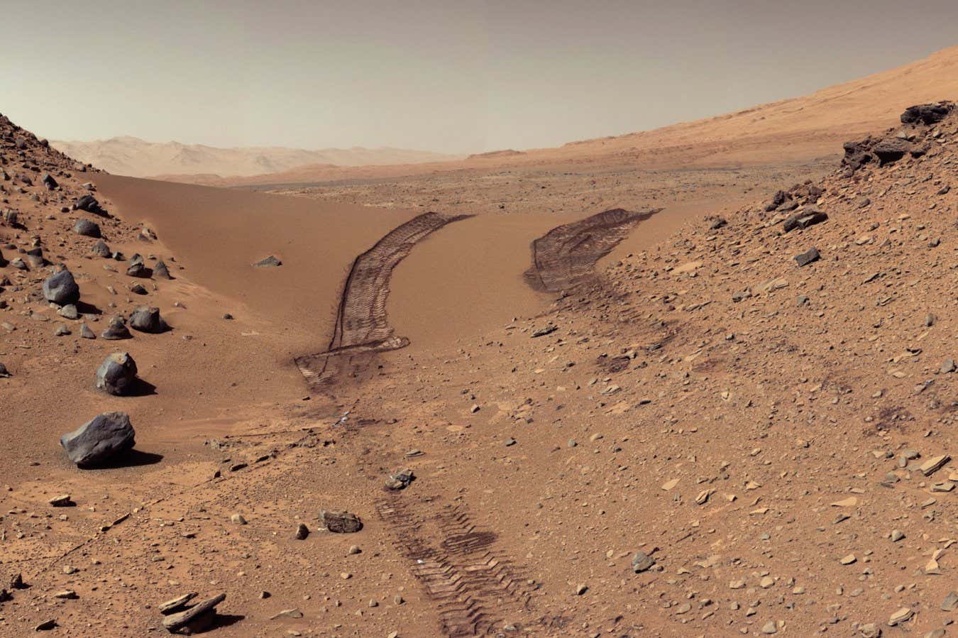 The Curiosity rover faced a five-mile (eight-kilometer) trek from its landing site to the foothills of Aeolis Mons, but driving across bedrock eroded into sharp points was destroying its wheels. In early 2014, the mission directed the rover across a sand drift at Dingo Gap, leaving behind the jagged bedrock for kinder, gravel-filled valley bottoms.