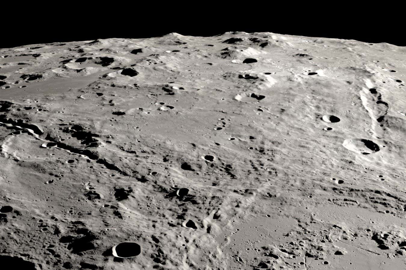 Two grand canyons on the moon radiating from the Schrödinger basin. The view is from orbit looking across the surface, like an astronaut in an approaching spacecraft