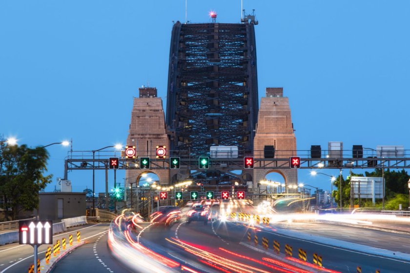Trails of car light going into Sydney Harbour Bridge at dusk