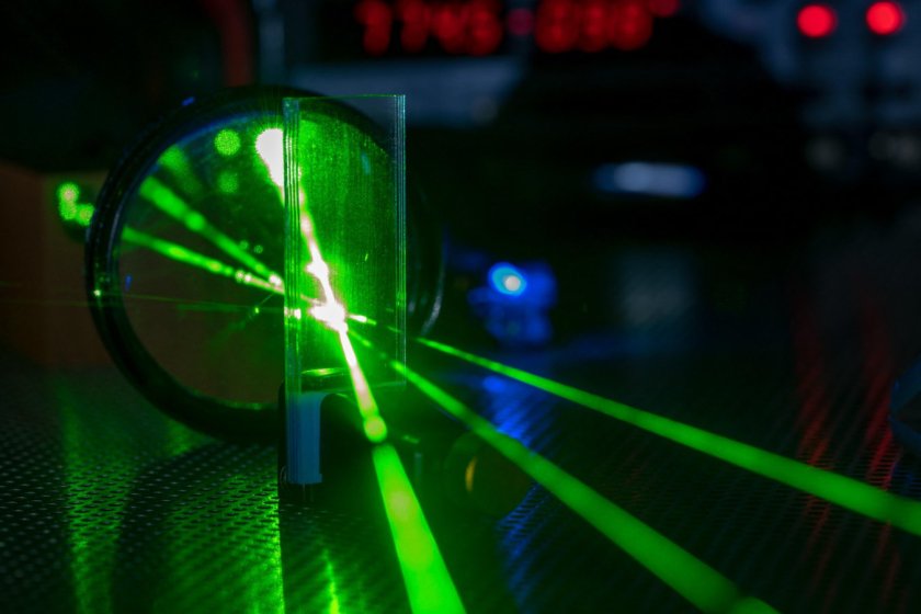 Green laser on optical table in a quantum optics laboratory